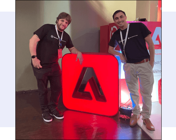 Improntus staff posing with the Adobe logo.