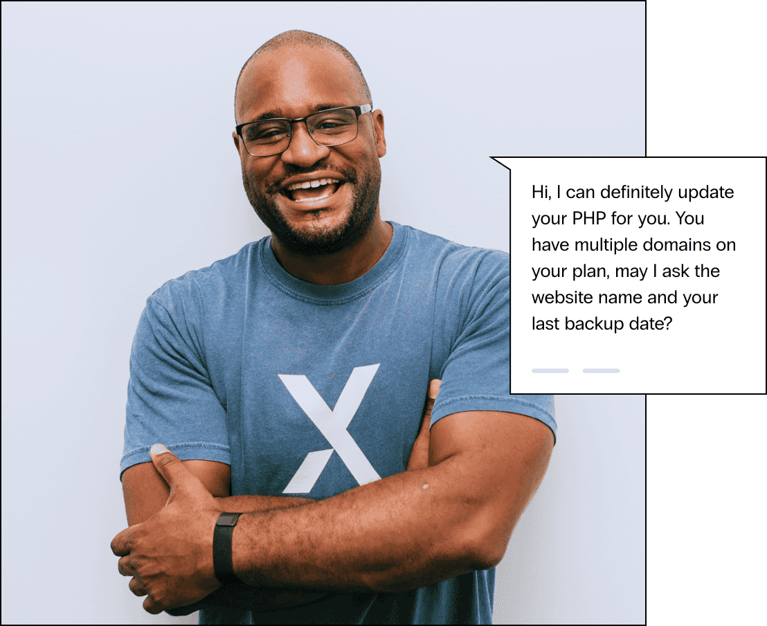 Nexcess hosting expert in glasses and a soft tshirt, he smiles with arms casually crossed, says I can definitely update your PHP for you. You have multiple domains on your plan, may I ask the website name and your last backup date?