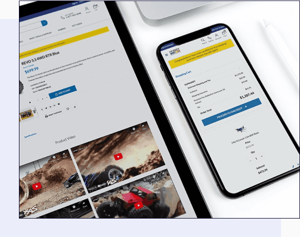 A phone and a tablet lying on a desktop, both open to the Hobby Wholesale website