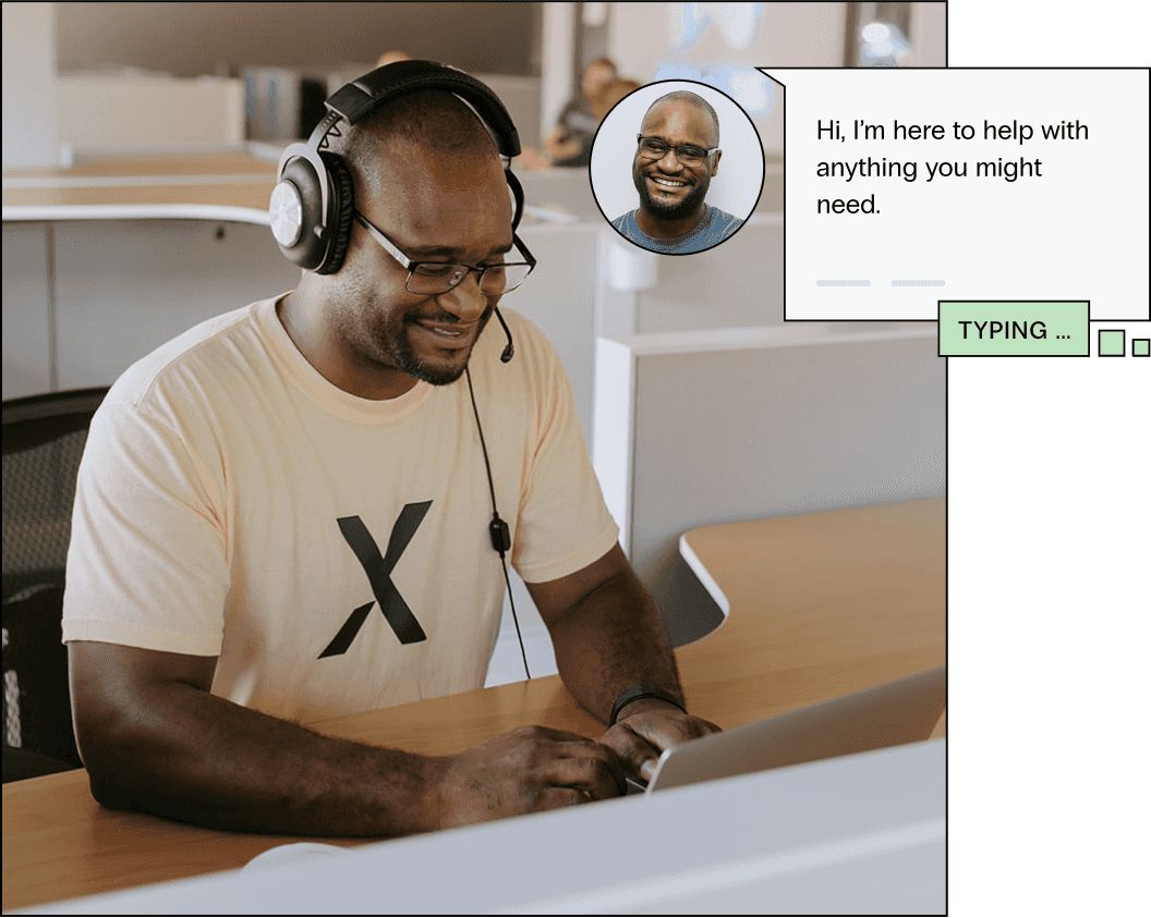 A WordPress support representative sits in a modern office, he smiles as he helps a customer via chat and by phone