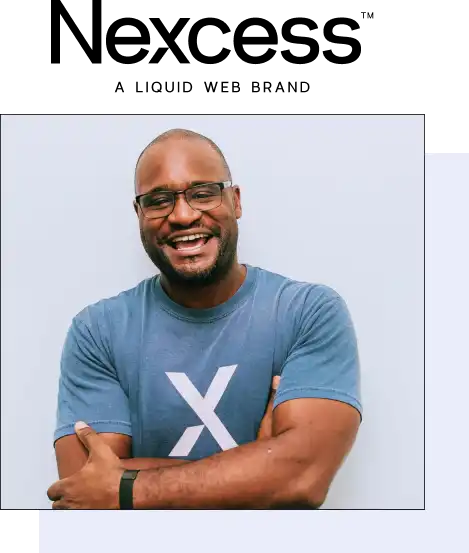 Nexcess hosting expert in glasses and a soft tshirt, he smiles with arms casually crossed